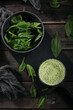 Glass of homemade healthy green smoothie with fresh baby spinach