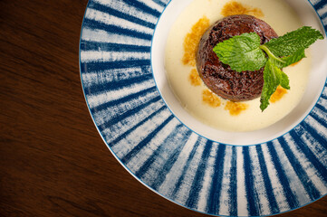 Wall Mural - Sticky Toffee Pudding over Creme Anglaise topped with Caramel 