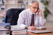 © Elnur - Old male employer and too much work in the office