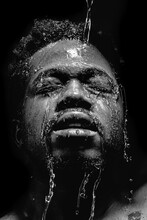 Grayscale Portrait Of Man Spilling Water On His Face