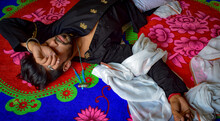 Man Wearing Black Shirt And White Textile Lying On Floral Floor Mat