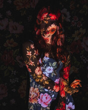 Portrait Of A Woman With Screen Projector Projecting Floral Pattern On Her
