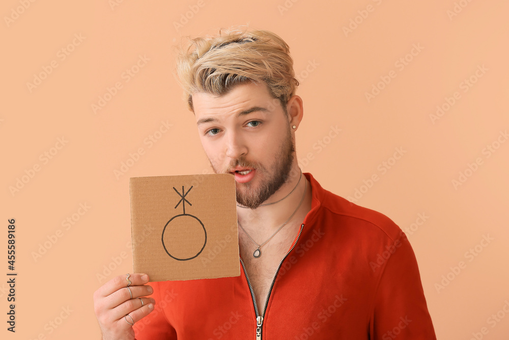 Non-binary young man on color background