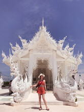Woman Standing In Front Of Dragon Designed Gate