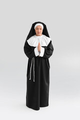 Wall Mural - Mature nun on light background