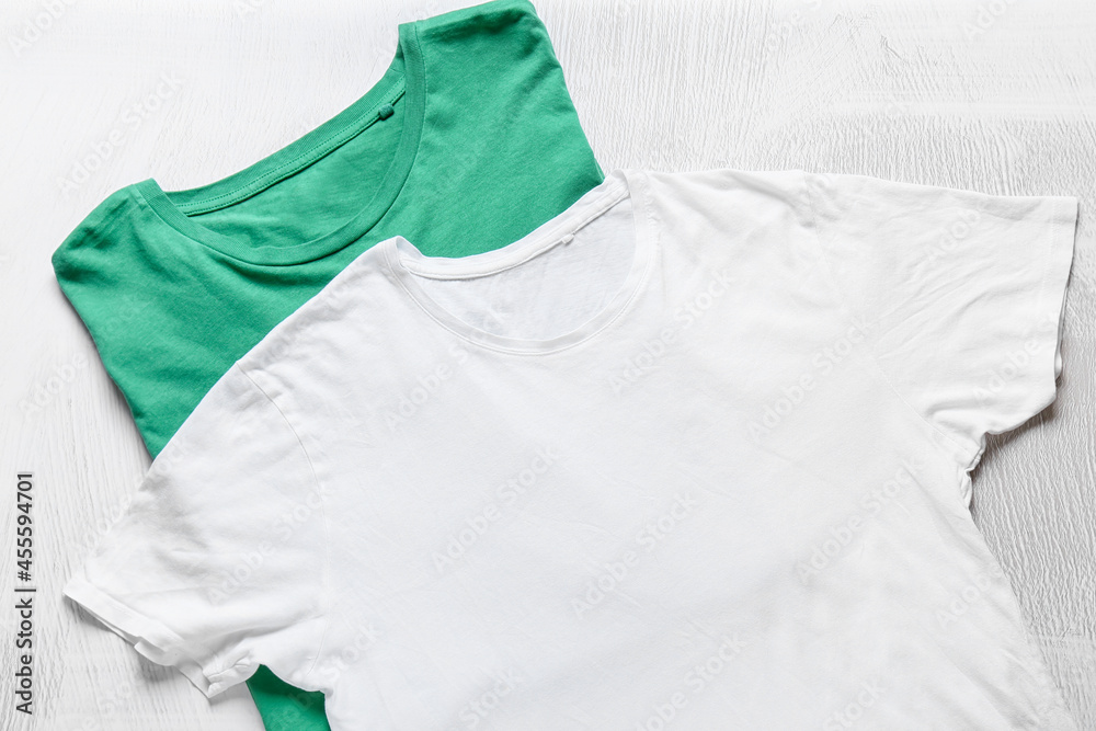 Stylish t-shirts on light background
