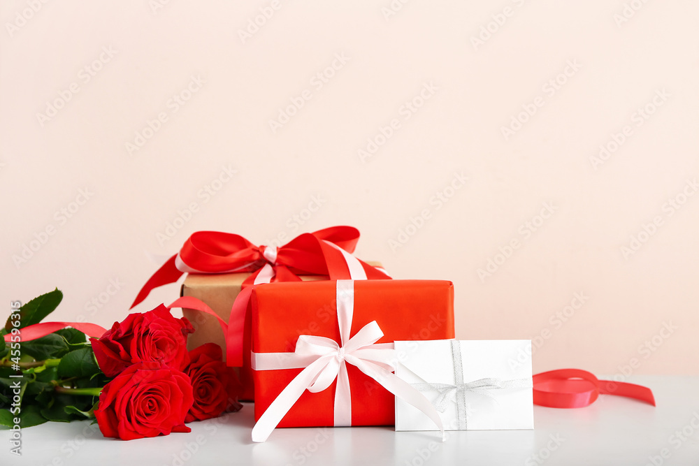Gifts for Valentine's Day and roses on table