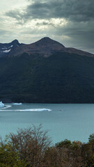 Wall Mural - Boat next to a huge mountain in a lake with ice