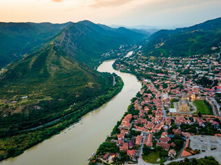 Aerial view of streets of Mtskheta village in Georgia with Svetitskhoveli Cathedral fortress