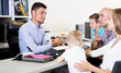 © JackF - Positive male seller offering variants of fabric for upholstery mattress to family