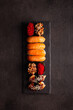 Japanese food, sushi on a black plate, top view