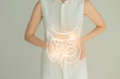 Woman in white clothes holding virtual intestine in hand. Handrawn human organ, detox and healthcare, healthcare hospital service concept stock photo