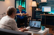 © DC Studio - Caucasian old woman using online conference video call for medical advice from doctor. Senior person using technology to ask about pills and treatment for disabled man in wheelchair