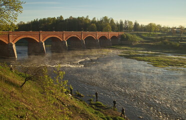 Wall Mural - Long brick bridge in sunny spring morning, Kuldiga, Latvia. 