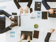 © xartproduction - Group of young business people working and communicating while sitting at the office desk together with colleagues sitting. business meeting. Desktop top view.