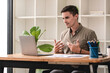 © Daenin - business man happily discussing work through laptop