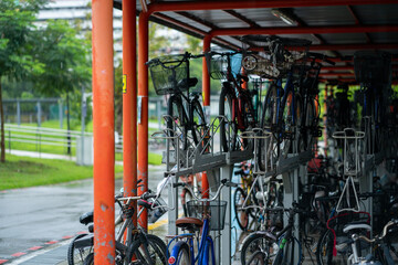 Sticker - Bicycles parked outside MRT station, Yishun, Singapore. Rainy wet day. Horizontal shot