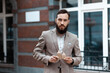 © Andrii Zastrozhnov - A model advertises a construction company. The man in a suit holds a cardboard.house. Secure real estate purchase.