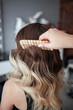 © Natalia Rzhevskaia - stylist hairdresser makes a hairstyle for a girl in his beauty salon, hollywood wave, beautiful hairstyle, hairdresser at work