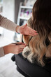 © Natalia Rzhevskaia - stylist hairdresser makes a hairstyle for a girl in his beauty salon, hollywood wave, beautiful hairstyle, hairdresser at work