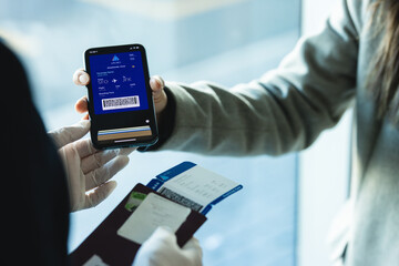 Passenger showing digital boarding pass to airline attendant