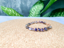 Wire Bracelet With Amethyst Stone And Shell On The Background.