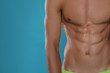 © New Africa - Shirtless man with slim body on light blue background, closeup. Space for text