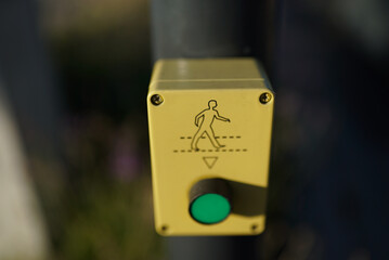 Selective of a traffic light button at a crossroad