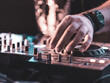 © Scopio - DJ playing music on mixer