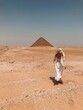© Scopio - Woman walking toward Pyramid