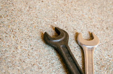 Wall Mural - wrench flat close up on wooden background