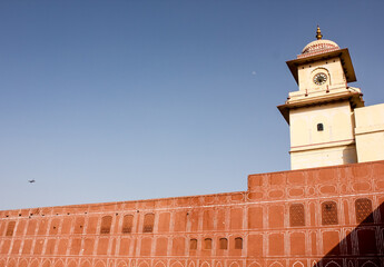 Poster - The old, red walls of the ancient City Palace against a blue sky in the city of Jaipur.