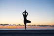 © Milles Studio/Stocksy - Unrecognizable female meditating in Vriksasana pose at sundown