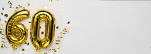 Golden Foil Balloon Number Sixty. Birthday Or Anniversary Card With The Inscription 60. Gray Concrete Background.