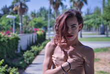 Young Adult Hispanic Transsexual Girl Covering Her Undeveloped Breasts With Her Hands. Concept Of Transsexuality, Inclusion And Diversity.