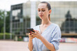 © Павел Костенко - Portrait of attractive and beautiful Caucasian business woman. Lady is using a smartphone. Business and networking concept.