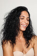 © Anna Tabakova/Stocksy - Beautiful hispanic model smiling