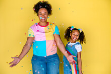 Happy Mom And Girl Under Falling Confetti