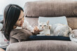 © Heng Yu/Stocksy - A woman petting her cat
