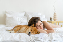 Woman And Dog Sleeping Together