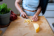 © Eloisa Ramos/Stocksy - Female cooker cutting cheese on the cutting board