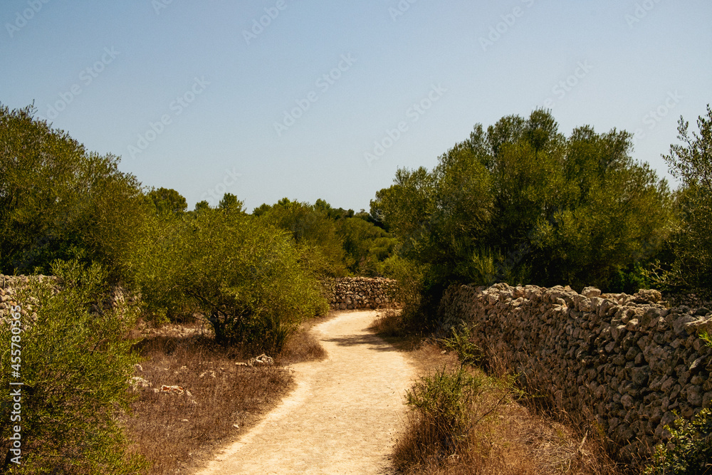 spanish unpaved street in the spanish countryside with stones sides. an ...