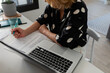 © Valentina Barreto/Stocksy - Woman working sitting on the desk at office