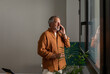© Valentina Barreto/Stocksy - Senior man talking by phone at office