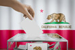 California flag, hand dropping ballot card into a box - voting, election concept - 3D illustration
