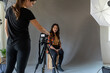 © Jayme Burrows/Stocksy - Woman Sets Up Tripod to Shoot Portraits
