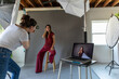 © Jayme Burrows/Stocksy - Woman Shoots Model in Photo Studio with Laptop
