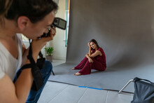 Woman Shoots Model In Photo Studio