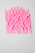 © Catherine MacBride/Stocksy - Lots of pink paper post its stuck on a wall