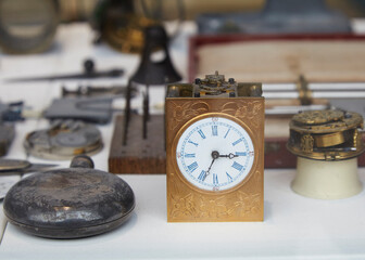 Mature Watchmaker repairing vintage pocket watch and clock on the workbench.  